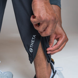 Close up view of our THETA core gym wear trackie ankle zip. These trackies are made for functional fitness and general gym wear use. Featuring the functionality of our ankle zips and paired with white nike metcon 8's.